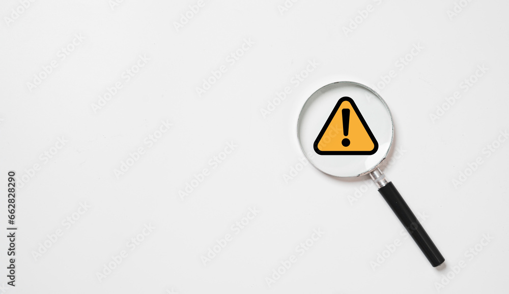 Black and yellow triangle caution warning sign inside of magnifier glass for notification error and maintenance concept. - obrazy, fototapety, plakaty 