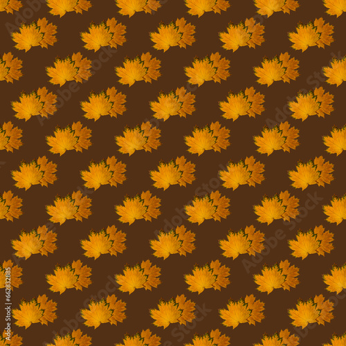 Seamless pattern of golden yellow maple leaves on a brown background. Design element. Textile