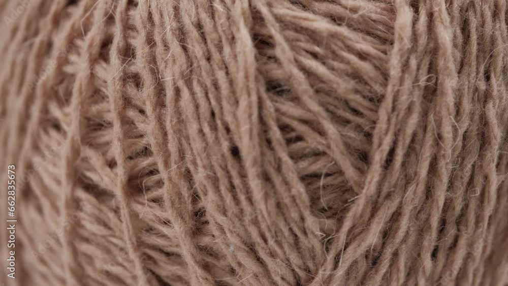 closeup rotation of a ball of natural yarn made of beige wool. needlework and crocheting or knitting. leisure, hobbies. macro. closeup rotation of a ball of natural yarn made of beige wool. needlework and crocheting or knitting. leisure, hobbies. macro.