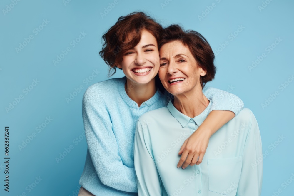 An elderly woman and a young girl. Mom and daughter are smiling.