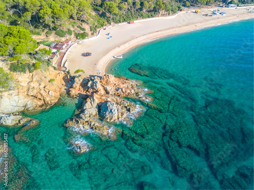 Fenals, Lloret de Mar Aerial view with Drone from the beach, Blue, turquoise, dense water, green vegetation, Mediterranean, transparent, nature, European quality tourism