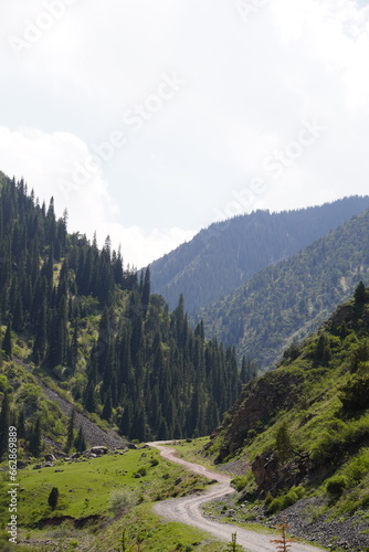 mountains, sky, hills, trees, forest, stones, clouds, winding road