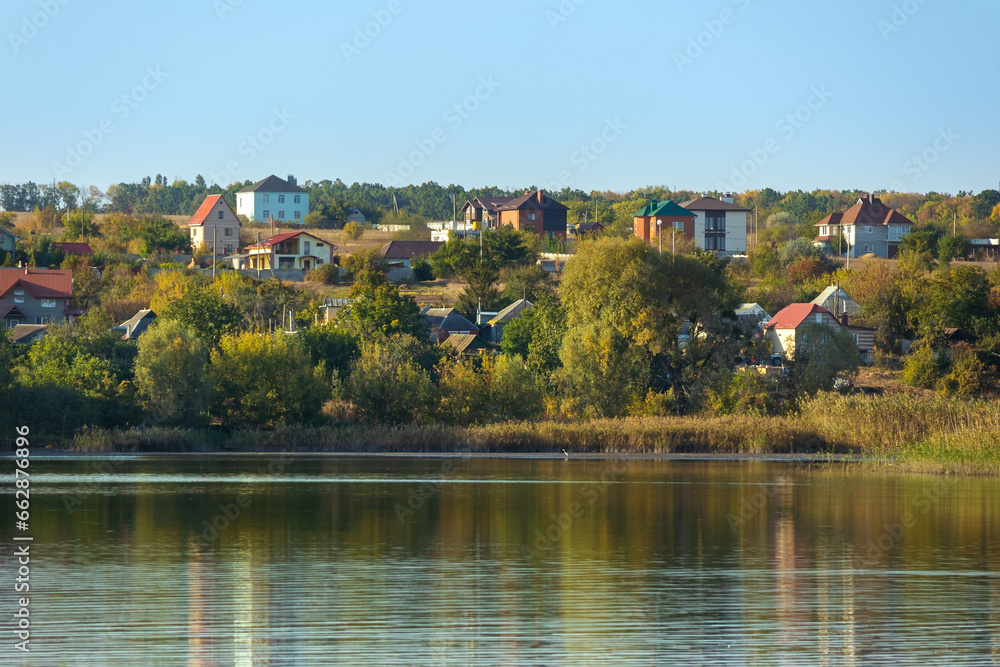 Village on the shore of a lake in Ukraine on an autumn sunny day