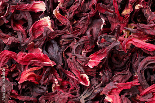 Dry hibiscus tea as background, top view
