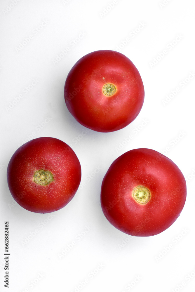 Three juicy red tomatoes on a white background. Three juicy red tomatoes on a white background.