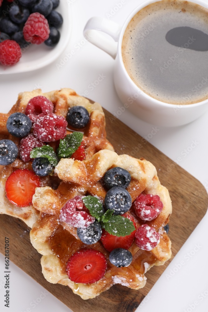 Delicious Belgian waffles with fresh berries on white table, flat lay Delicious Belgian waffles with fresh berries on white table, flat lay