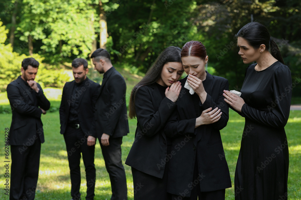 Sad people in black clothes mourning outdoors. Funeral ceremony Sad people in black clothes mourning outdoors. Funeral ceremony