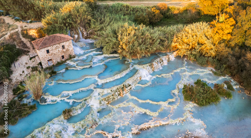 Fotografie Italy Saturnia thermal hot springs aerial view of Cascate del Mulino at sunset i