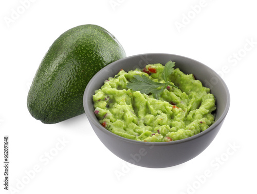 Delicious guacamole and fresh avocado isolated on white