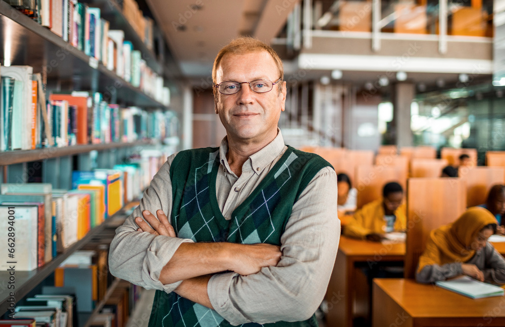 Portrait of a middle aged male librarian in the college library Portrait of a middle aged male librarian in the college library