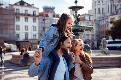 Young tourist family walking and exploring the Rossio in Lisbon photo