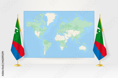 World Map between two hanging flags of Comoros flag stand.