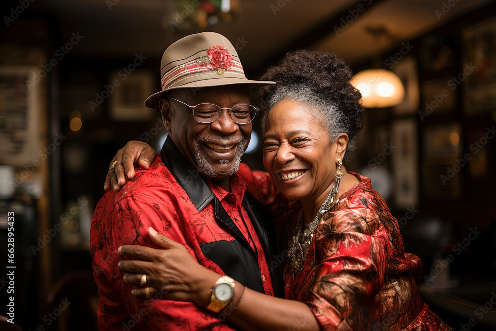 An African American retired couple shares a romantic dance in their kitchen, radiating enduring love.