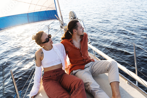 Young attractive couple relaxing on the sailboat during sailing in the sea © blackday