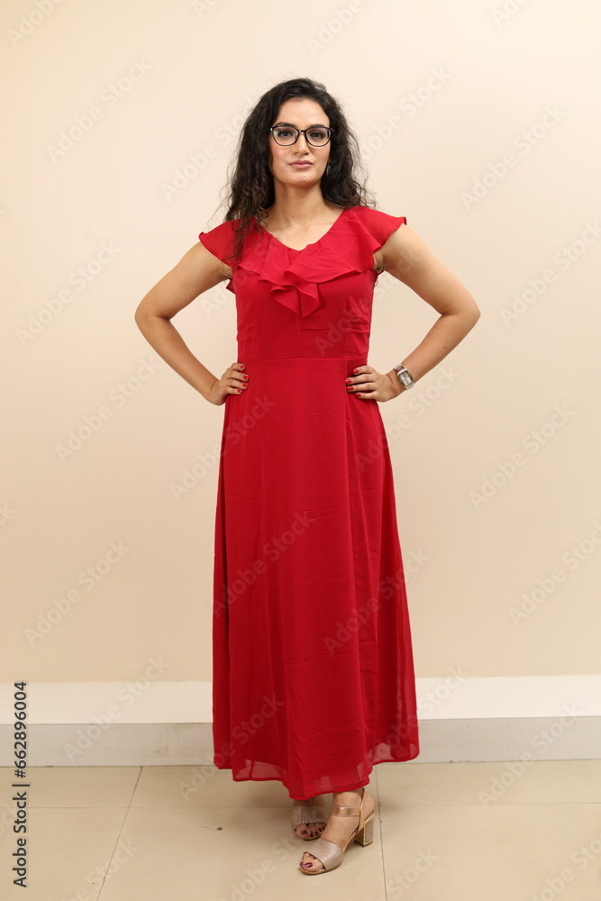 Lady flaunting. Beautiful portrait of a confident, sexy young lady in red gown flaunting and wearing eyewear. Lady flaunting. Beautiful portrait of a confident, sexy young lady in red gown flaunting and wearing eyewear.
