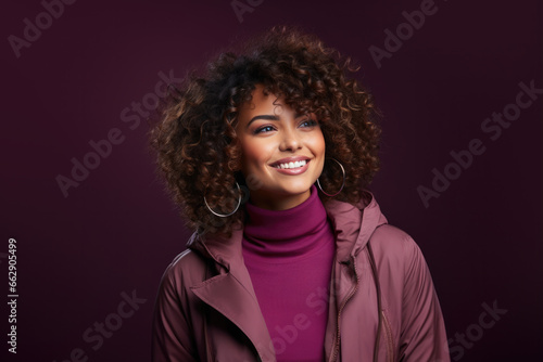 Portrait of a beautiful smiling girl on a purple background