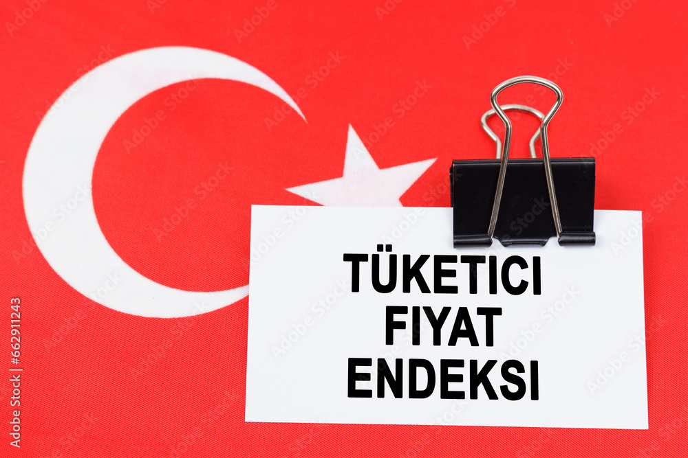 Fototapeta premium On the flag of Turkey lies a business card with the inscription - consumer price index