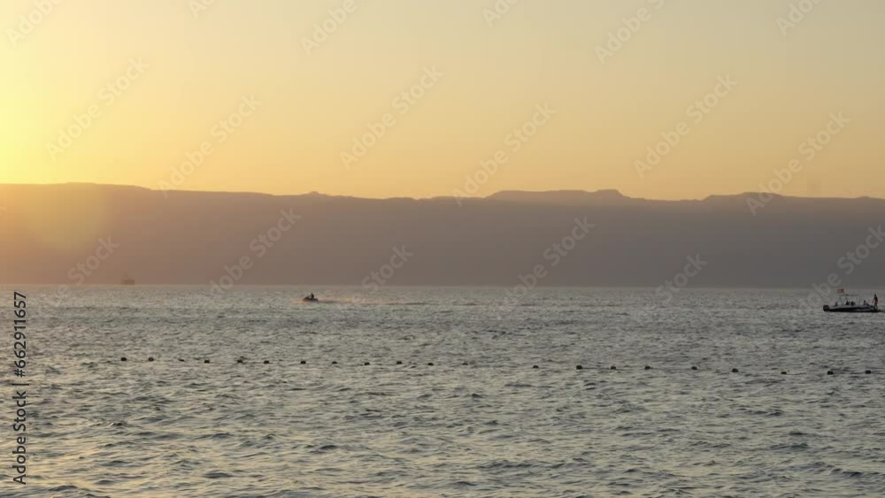 playing jetki . Tropical resort in Tala Bay, Hashemite Kingdom of Jordan. Red sea, gulf of Aqaba. View on Israel and Egypt on the other coast playing jetki . Tropical resort in Tala Bay, Hashemite Kingdom of Jordan. Red sea, gulf of Aqaba. View on Israel and Egypt on the other coast