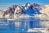 East Greenland landscape with coastline, icebergs and mountains