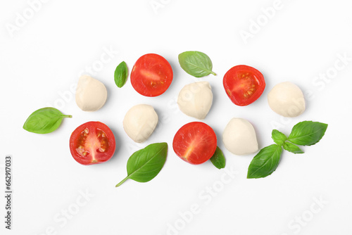 Fototapeta Naklejka Na Ścianę i Meble -  Mozzarella, tomatoes and basil on white background, flat lay. Caprese salad ingredients