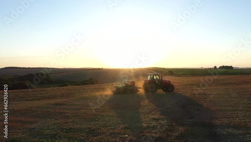 Tractor working in the field with a seeder.