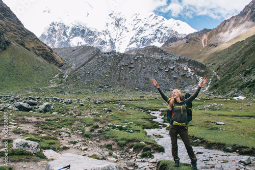 happy woman with backpack recreating in tranquil National Park for exploring wanderlust