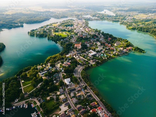 Aerial view of the picturesque Trakai, Lithuania, surrounded by a tranquil lake and lush greenery photo
