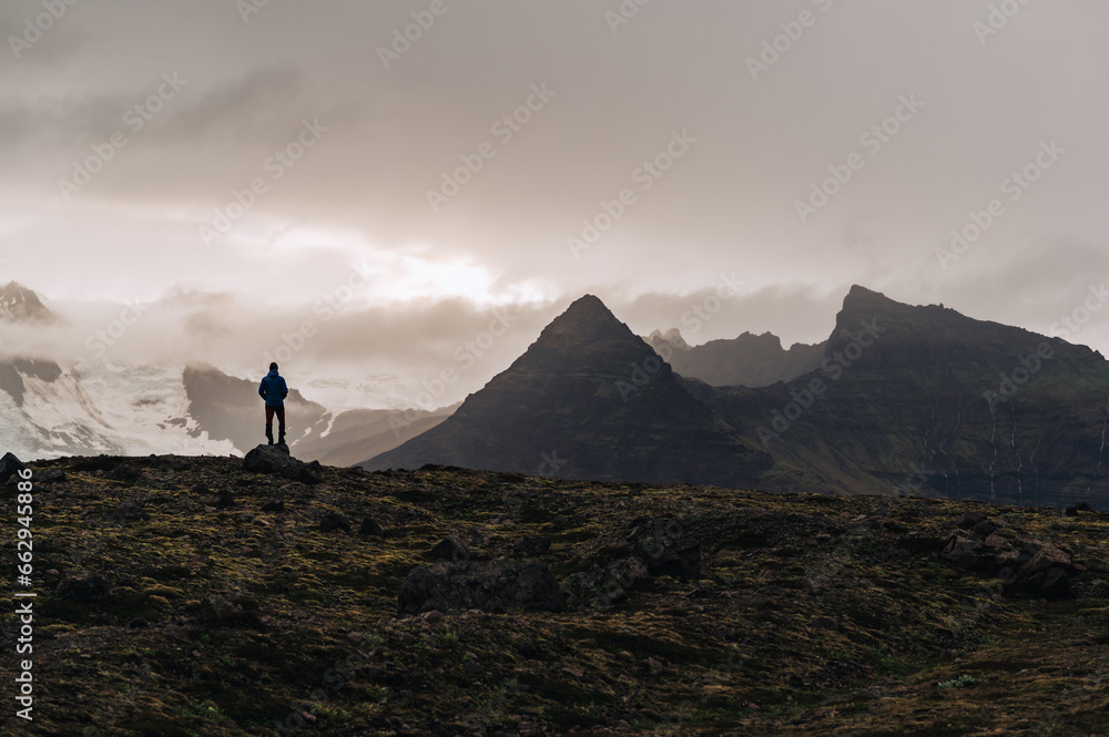 A man on the top of the mountain enjoying nature in Iceland.