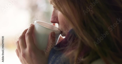 Cute woman with a white cup drinks hot chocolate, tea or coffee