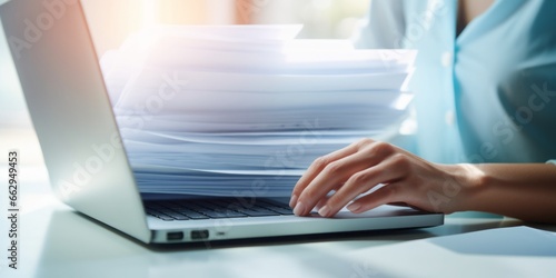 Efficient Digital Workflow: A Closeup of a Womans Hands Holding Papers in Front of Her Laptop, Showcasing Digitization, Scanning, Paperwork Management, Administrative Efficiency, Personnel Oversight
