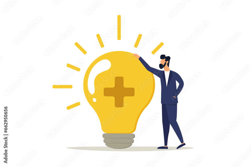 Business man standing with a bright light bulb idea with a positive sign. Positive thinking brings success in work and life, inspiration and happiness in work concept. Business man standing with a bright light bulb idea with a positive sign. Positive thinking brings success in work and life, inspiration and happiness in work concept.