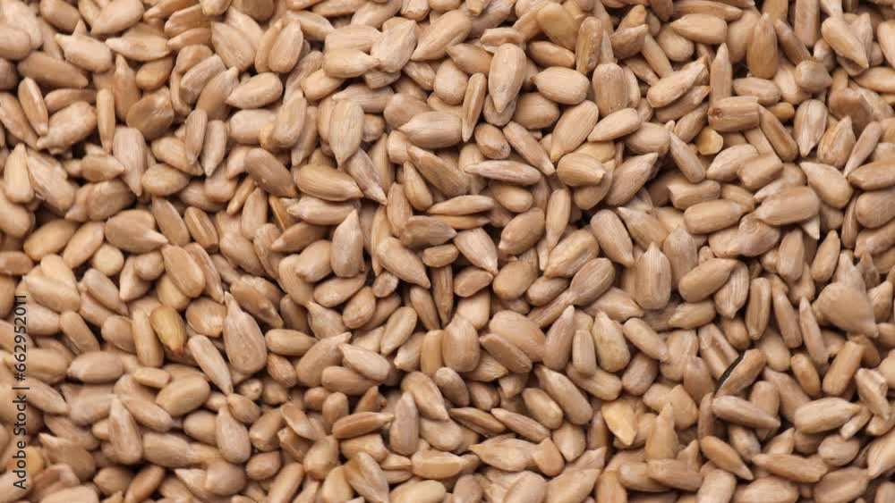 Peeled sunflower seeds, rotation in circle. A raw sunflower seeds, Turning. selective focus. Peeled sunflower seeds, rotation in circle. A raw sunflower seeds, Turning. selective focus.