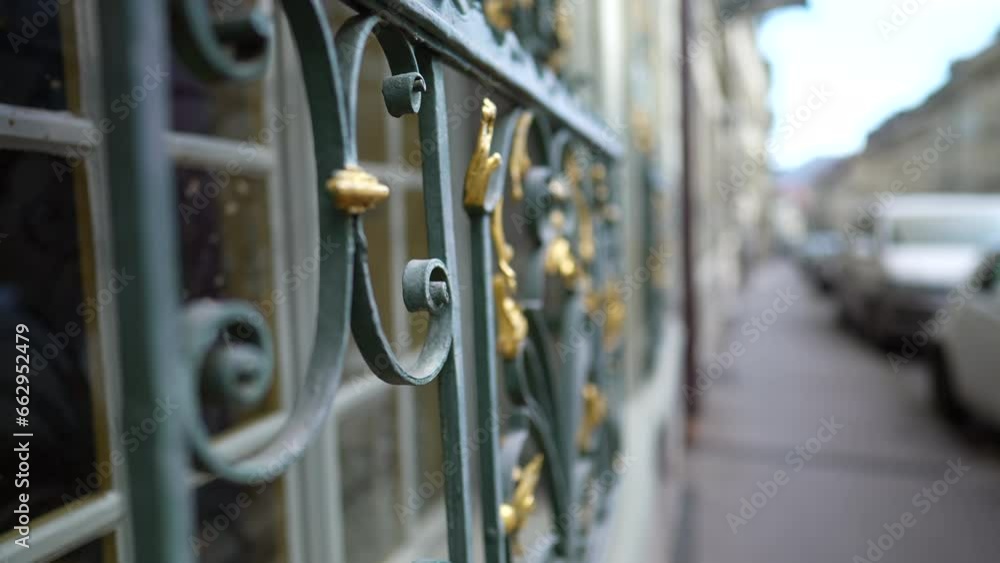 Historic Craft -Detailed Metal Adornment on Ancient Building exterior overlooking city sidewalk..Golden art ornamentation in Traditional architecture Facade Historic Craft -Detailed Metal Adornment on Ancient Building exterior overlooking city sidewalk..Golden art ornamentation in Traditional architecture Facade