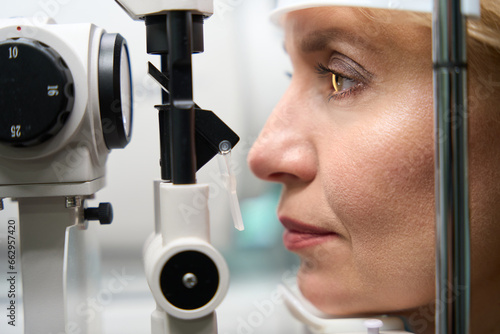 Middle-aged client undergoing an ophthalmological examination photo