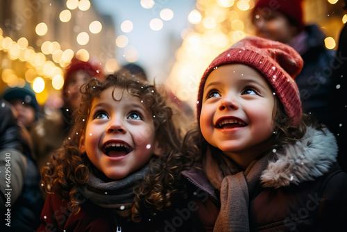 Small happy children having fun together in the street on winter holidays