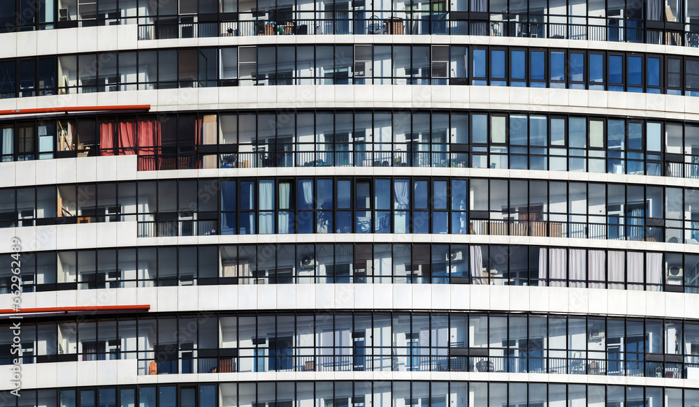 White round house facade with glazed balconies. Abstract modern architecture - obrazy, fototapety, plakaty 
