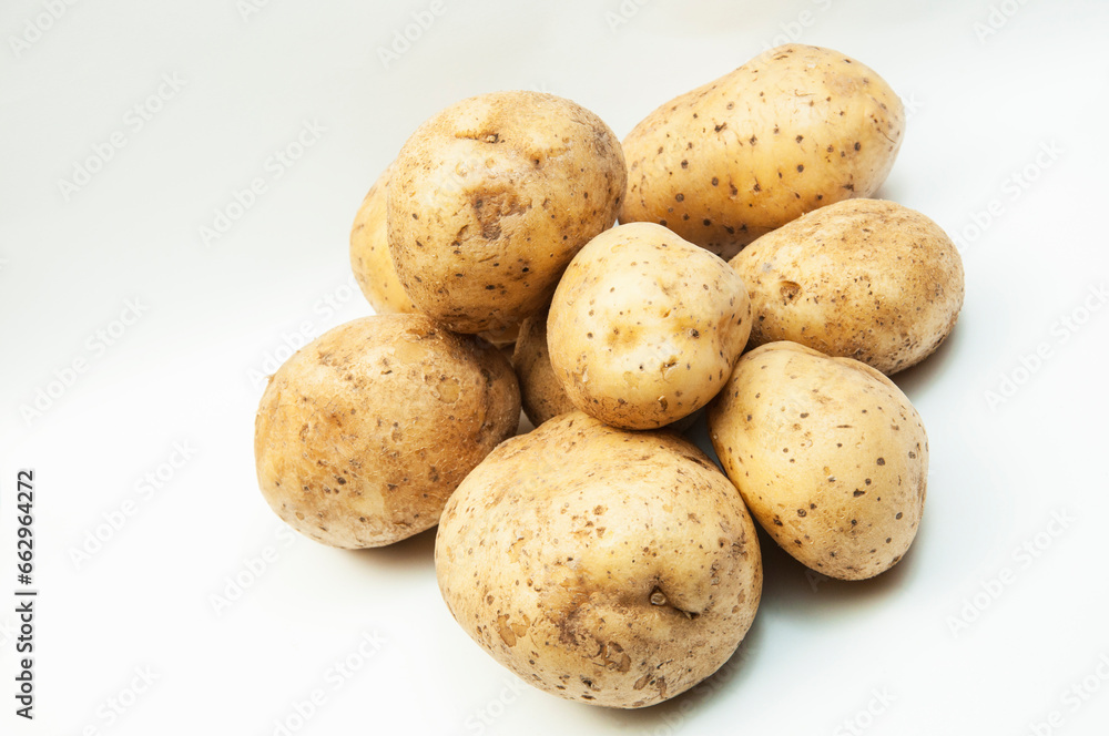 yellow selected potatoes on a white background. the concept of a good harvest of potatoes yellow selected potatoes on a white background. the concept of a good harvest of potatoes