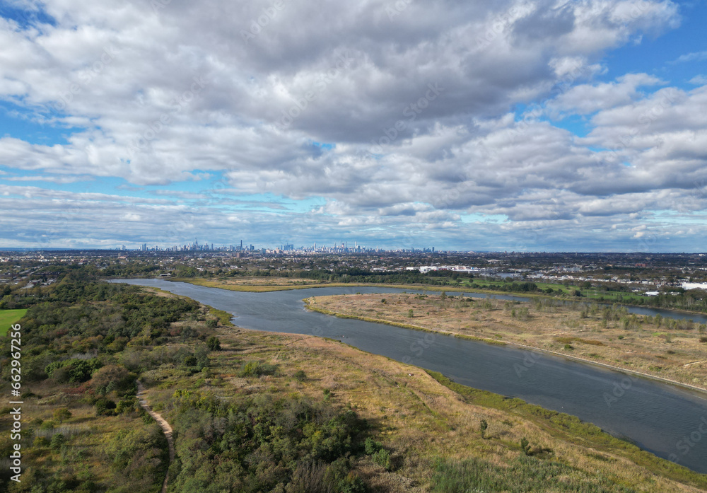 aerial view of manhattan skyline from marine park (drone image, nyc buildings, shell bank creek in the foreground) distance, far away, public park in brooklyn, new york (distant perspective)