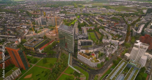 Aerial drone footage of Dusseldorf city , buildings and city streets at sunset photo