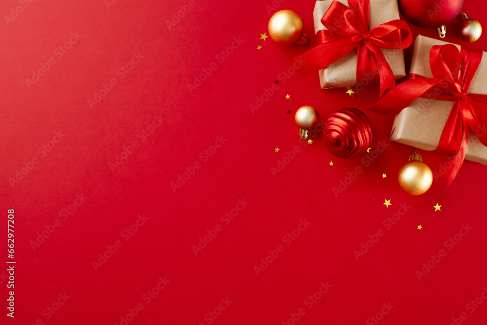 Seeking out meaningful New Year's presents. Top view flat lay of gift boxes, christmas tree baubles, stars on red background with advert placeholder Seeking out meaningful New Year's presents. Top view flat lay of gift boxes, christmas tree baubles, stars on red background with advert placeholder