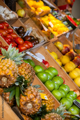 Pineapples, apples, tomatoes and lemons in a greengrocer's market