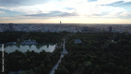 Aerial 4k view of Parque El Retiro in Madrid, Spain at a golden hour sunrise