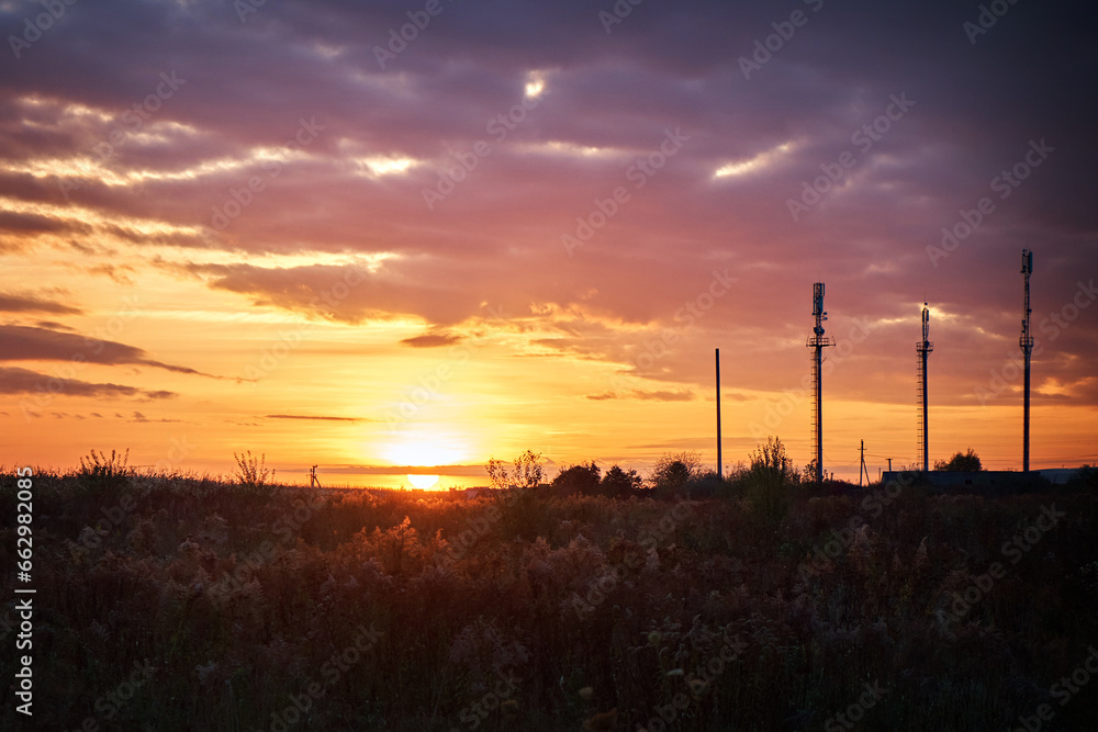 Mobile phone towers at sunset in autumn. Sunset in the countryside.