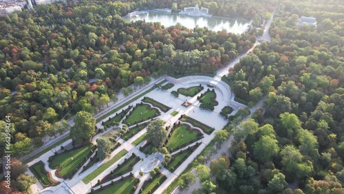 Aerial 4k view of Parque El Retiro in Madrid, Spain at a golden hour sunrise