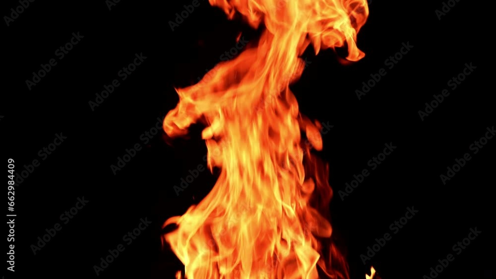 Huge bonfire rising up in the darkness. Dangerous red flame going up at night. Huge bonfire rising up in the darkness. Dangerous red flame going up at night.