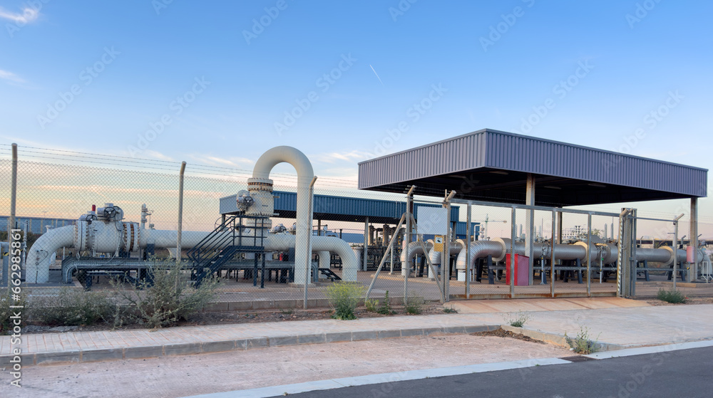 Natural gas transmission station in Spain. Spanish Gas System in Sagunto. Chemical factory. Natural gas production and Crude oil solution. Chimney smokestack emission. Gas Processing Plant on sunset.