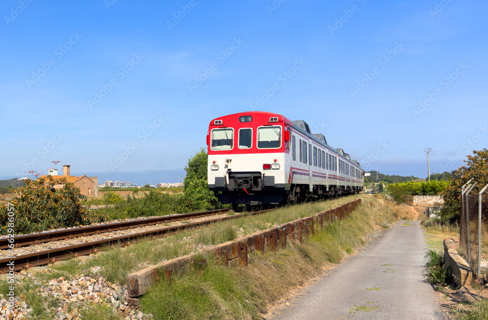 Train on railway. Spain regional commuter train in motion on railway. Spanish National Rail Network. Travel by train in European countries. Train against of mountains drive on railway Train on railway. Spain regional commuter train in motion on railway. Spanish National Rail Network. Travel by train in European countries. Train against of mountains drive on railway