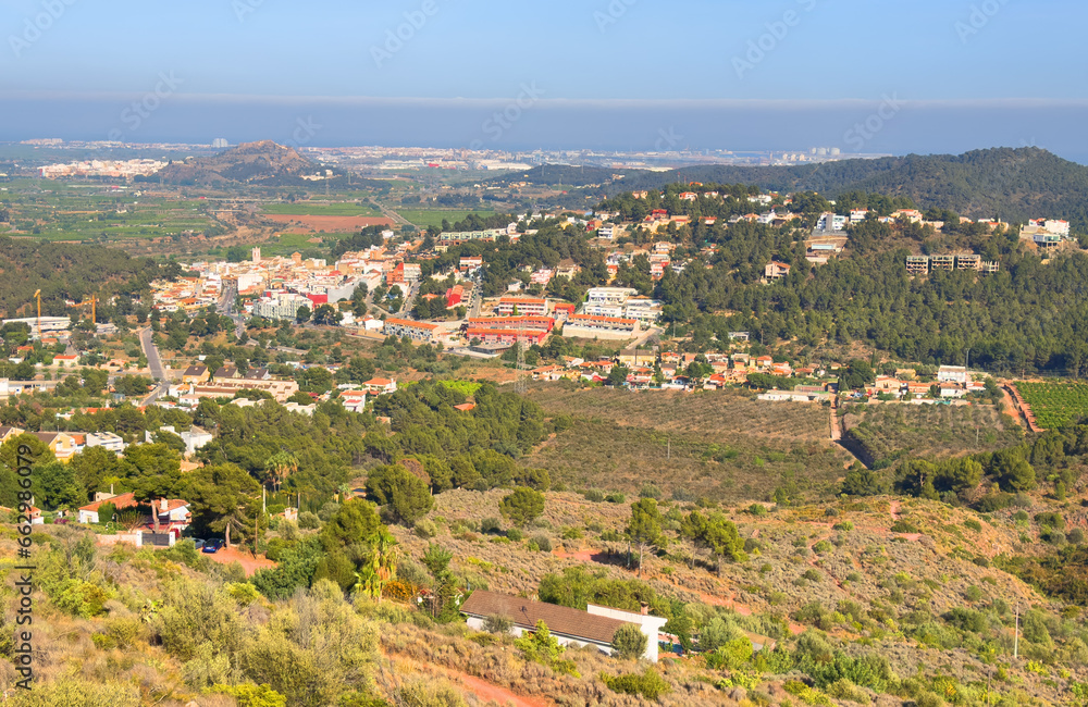 Villa in mountains. Mountains landscape with houses on hill. Towhouse and Home on hills. House in mountains. Rural landscape with hills. Houses on Mountain with nature scenery in Gilet Town in Spain.