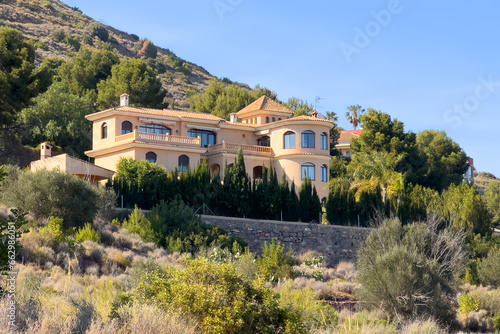 Villa in mountains. Mountains landscape with houses on hill. Towhouse and Home on hills. House in mountains. Rural landscape with hills. Houses on Mountain with nature scenery in Gilet Town in Spain. photo