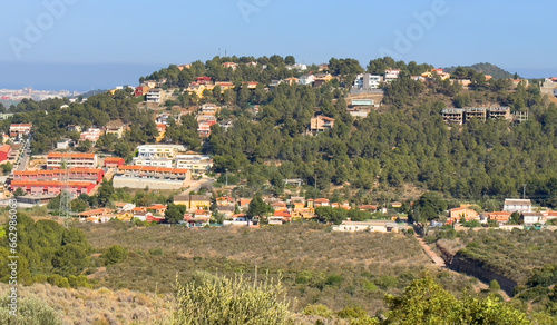 Villa in mountains. Mountains landscape with houses on hill. Towhouse and Home on hills. House in mountains. Rural landscape with hills. Houses on Mountain with nature scenery in Gilet Town in Spain. photo